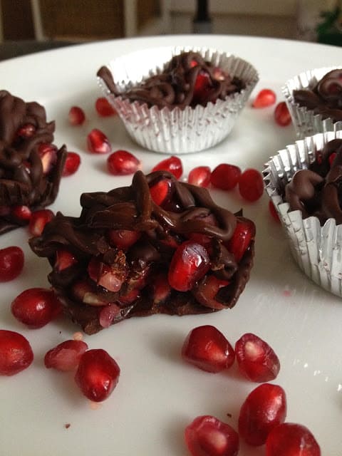 Chocolate pomegranate clusters on a white plate