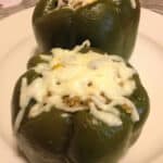 Green stuffed peppers covered in melted cheese