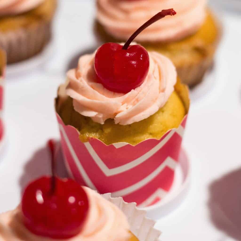 Shirley Temple cupcakes topped with a cherry