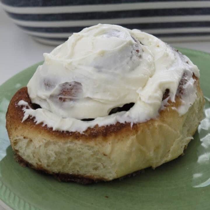 Large cinnamon roll slathered in cream cheese icing