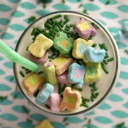 Milkshake topped with Lucky Charms marshmallows and green sprinkles