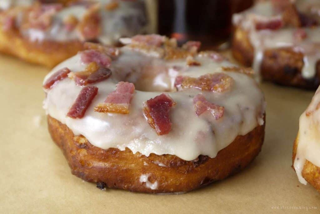 Closeup of a maple glazed donut topped with bacon