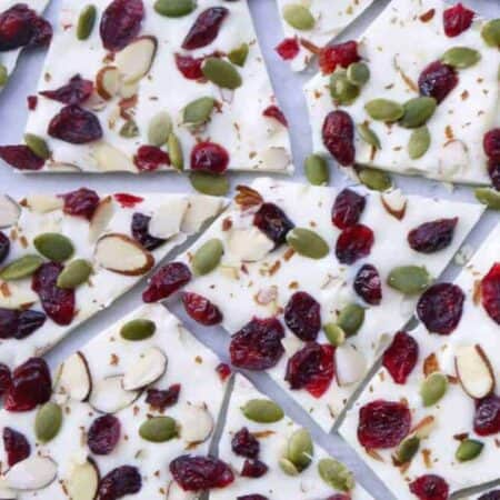 White chocolate bark covered in dried cranberries and nuts, broken into pieces