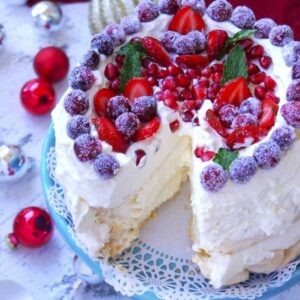 Pavlova with Mascarpone Whipped Cream: This cloud-like meringue cake has a delicate, crisp crust and is light and fluffy on the inside. Top it with my favorite mascarpone whipped cream and fresh fruit for a heavenly dessert! | stressbaking.com