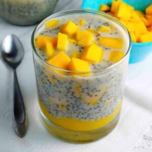 Chia pudding layered with mango puree and topped with fresh mango