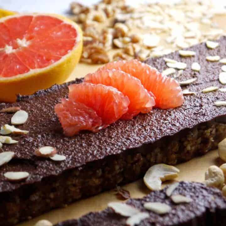 Chocolate grapefruit tart topped with sliced almonds and grapefruit slices