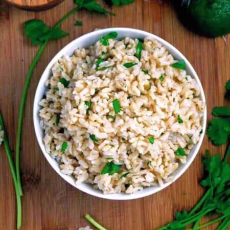 Cilantro Lime Brown Rice in a white bowl on a wood counter