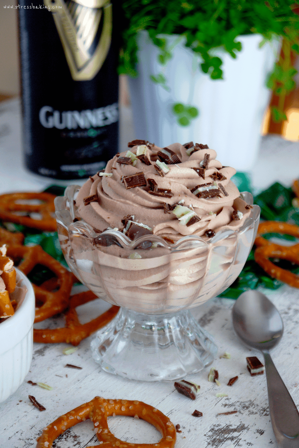 Dessert glass filled with chocolate Guinness whipped cream and topped with chopped Andes mints
