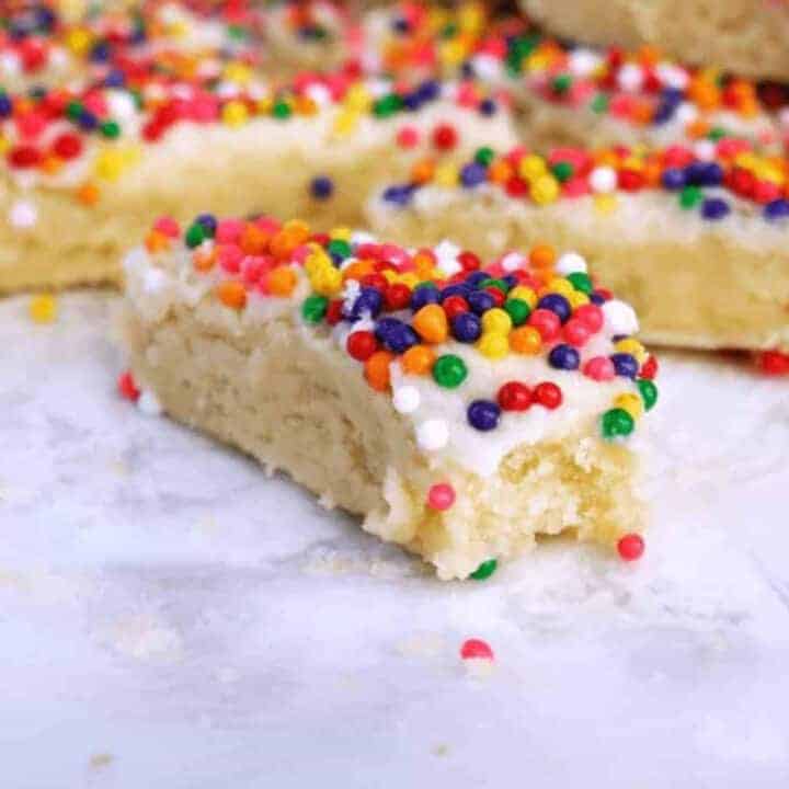 Sugar cookie bars topped with brightly colored round sprinkles