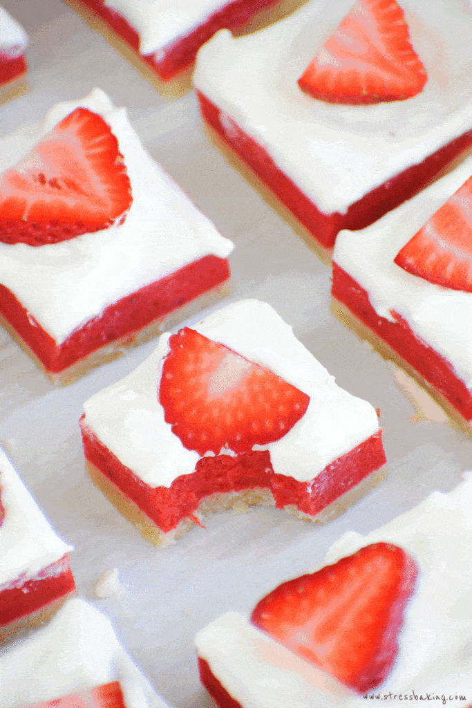 A vibrant strawberry rhubarb bar with a bite taken out