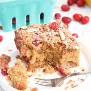 Paleo Cranberry Coffee Cake: Tender cake is packed with tart cranberries and a hint of orange zest, and loaded with slivered almonds and a sweet crumb topping. | stressbaking.com