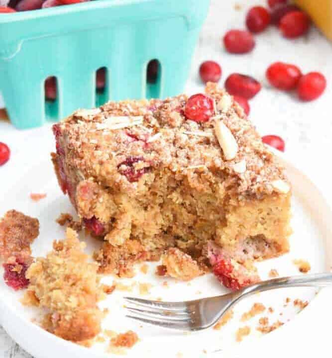 Paleo Cranberry Coffee Cake: Tender cake is packed with tart cranberries and a hint of orange zest, and loaded with slivered almonds and a sweet crumb topping. | stressbaking.com