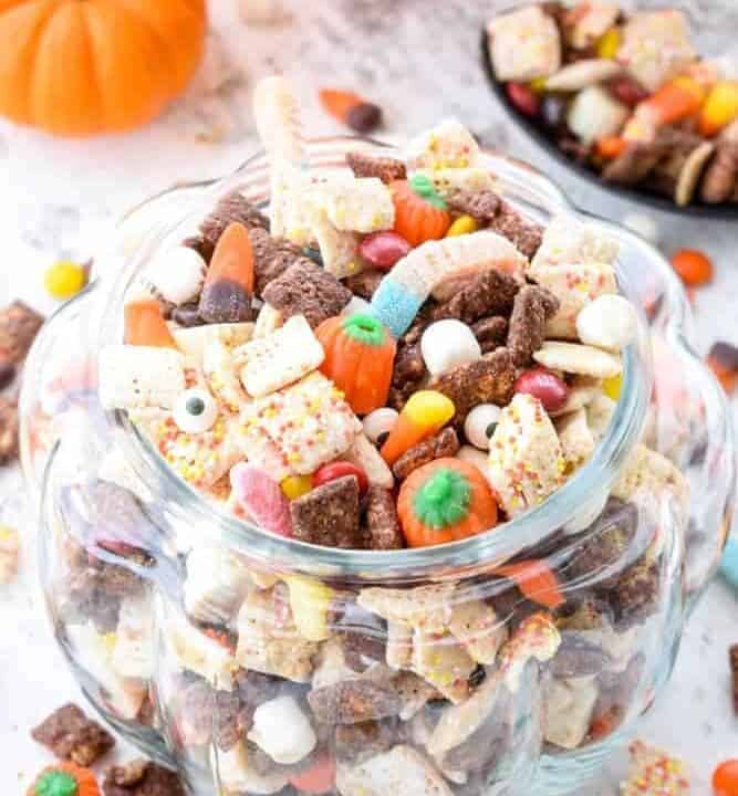Halloween Puppy Chow: Whether you call it puppy chow or muddy buddies, the addition of Halloween candy and autumn colors turn this into the perfect festive party snack! | stressbaking.com