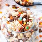 Halloween Puppy Chow: Whether you call it puppy chow or muddy buddies, the addition of Halloween candy and autumn colors turn this into the perfect festive party snack! | stressbaking.com