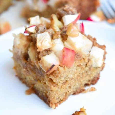 Apple cinnamon coffee cake square topped with chopped red apples
