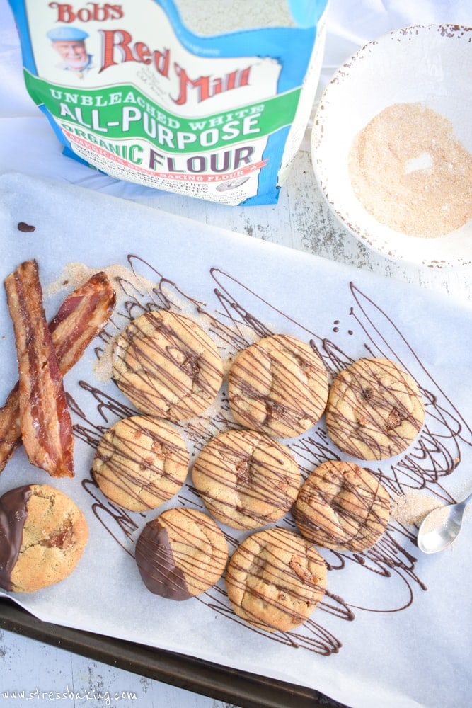Maple Bacon Snickerdoodles: Chewy, soft snickerdoodles are kicked up a notch with maple flavor, candied bacon, and a drizzle of dark chocolate! | stressbaking.com