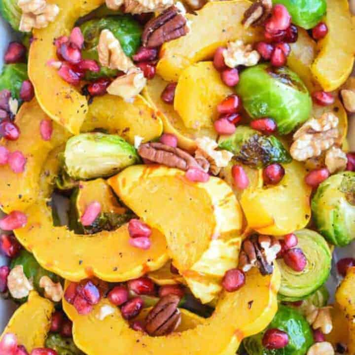 Colorful roasted delicata squash, brussels sprouts, pecans and pomegranate arils