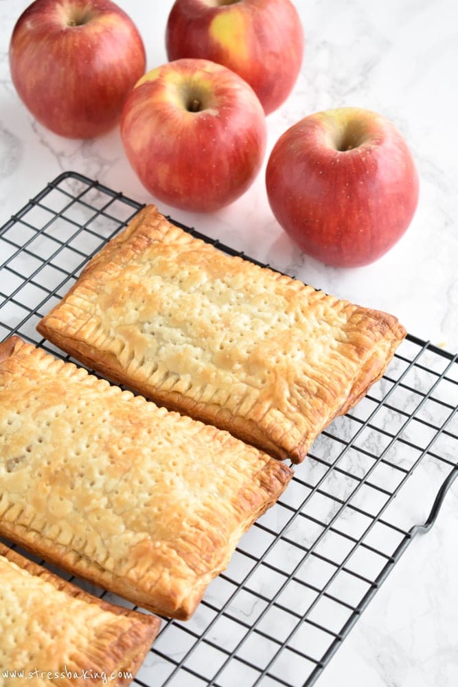 Homemade Apple Cinnamon Toaster Strudel: Nostalgia at its best! Puff pastry envelops warm a warm apple cinnamon filling and is topped with a hearty vanilla cream cheese drizzle. | stressbaking.com