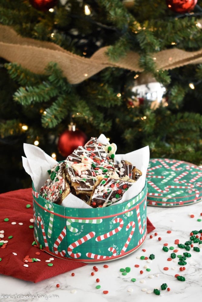 Christmas Crack: Warning: This is SUPER addictive! Saltines are covered with an easy caramel sauce, two types of chocolate, crushed and chopped peppermint, and assorted holiday sprinkles. This is absolute holiday treat perfection. | stressbaking.com #christmasdessert #christmastreat #holidaydessert #holidaytreat