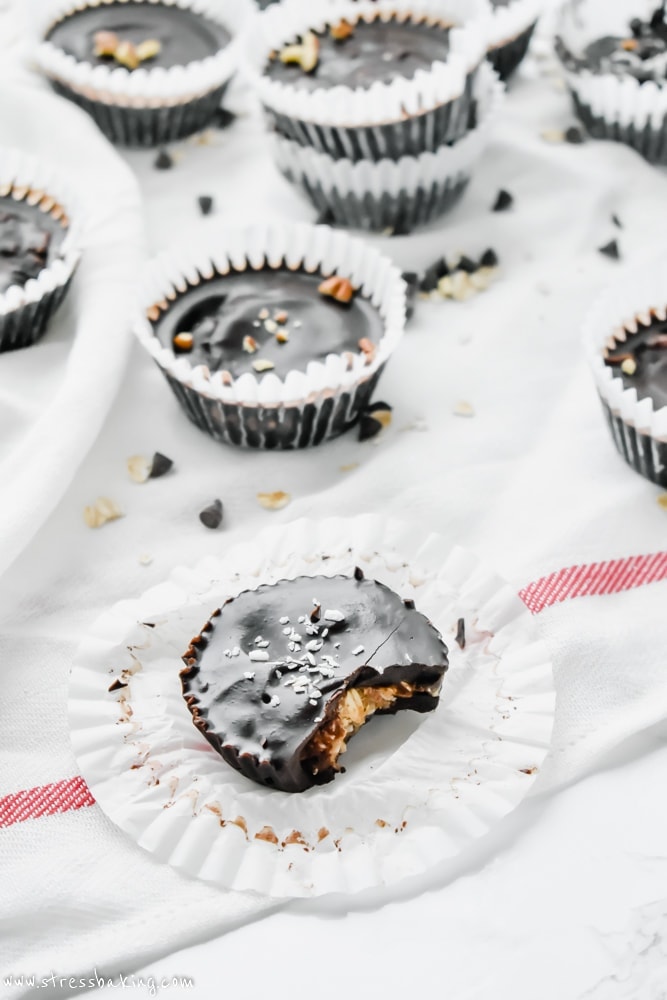 Paleo No-Bake Cowboy Cookie Cups: These cookie cups are like an almond butter cup and a cowboy cookie had a baby. Chewy oats, coconut and crunchy pecans are coated in smooth chocolate for a no-bake, no refined sugar, no gluten, no dairy, all paleo dessert! | stressbaking.com #stressbaking #cowboycookies #cookiecups #nobake #nobakedessert #dessert #almondbutter #paleo #glutenfree #refinedsugarfree #dairyfree #vegan 