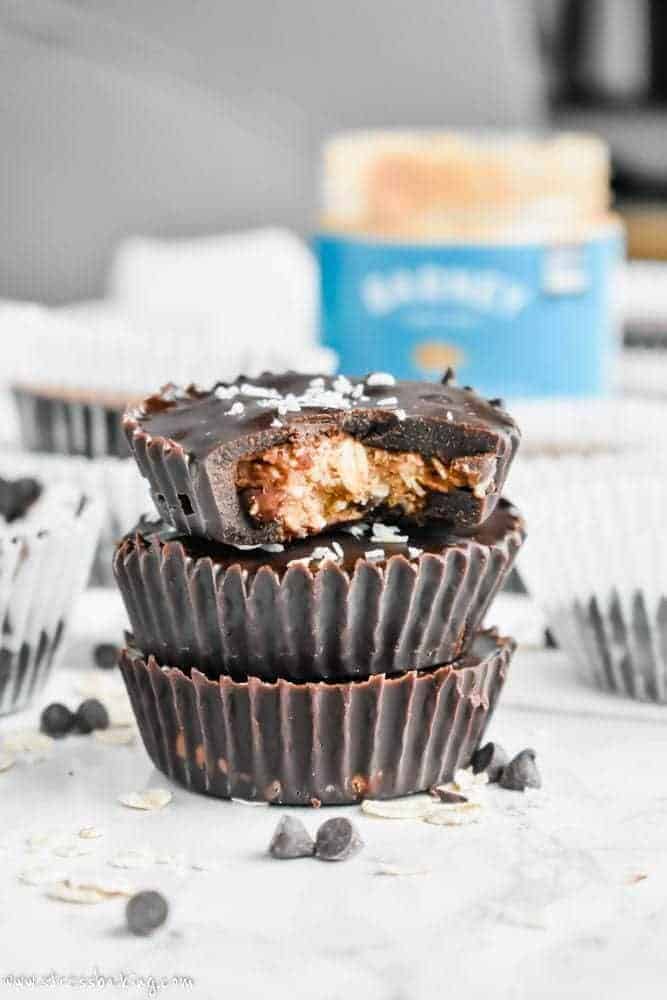 Paleo No-Bake Cowboy Cookie Cups: These cookie cups are like an almond butter cup and a cowboy cookie had a baby. Chewy oats, coconut and crunchy pecans are coated in smooth chocolate for a no-bake, no refined sugar, no gluten, no dairy, all paleo dessert! | stressbaking.com #stressbaking #cowboycookies #cookiecups #nobake #nobakedessert #dessert #almondbutter #paleo #glutenfree #refinedsugarfree #dairyfree #vegan 