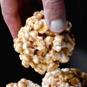 A popcorn ball being lifted from a pile
