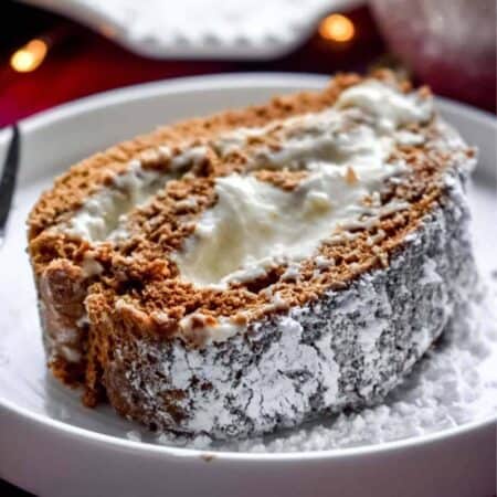 A slice of Gingerbread Cake Roll with Eggnog Cream Cheese Filling