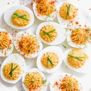 Deviled eggs topped with chives, dill, and smoked paprika