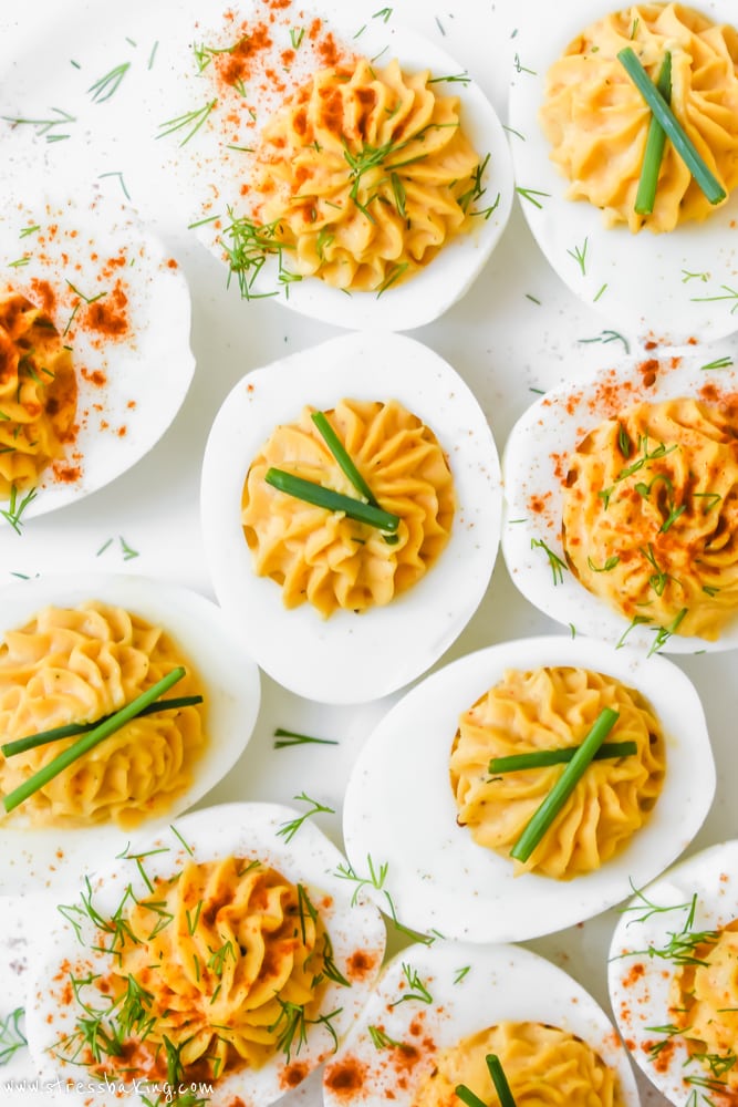 Deviled eggs topped with chives, dill, and smoked paprika