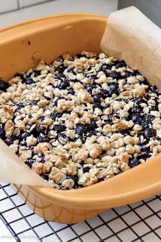 A yellow pan full of blueberry oatmeal bars