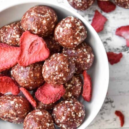 Strawberry Cashew Energy Bites in a bowl with freeze dried strawberries