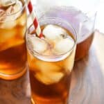 Cold brew coffee in tall glasses of ice with red and white straws