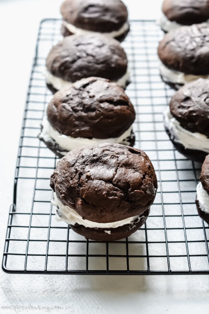 Many chocolate whoopie pies on a wire rack