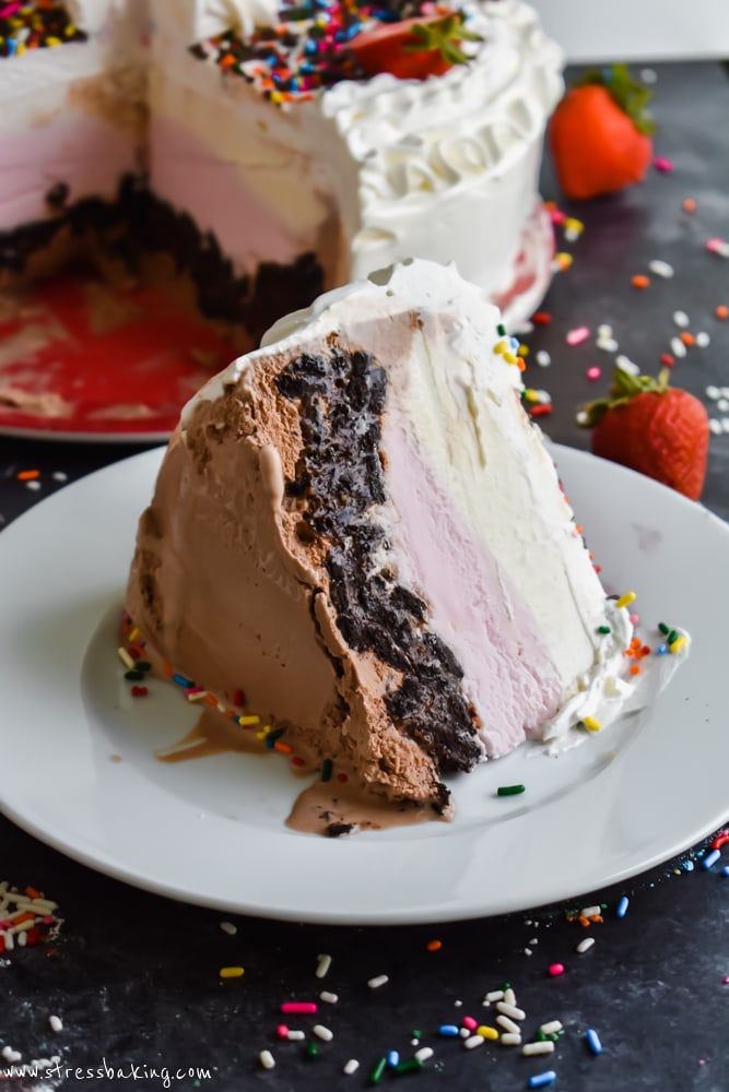 A slice of Neapolitan Crunch Ice Cream Cake on its side on a white plate