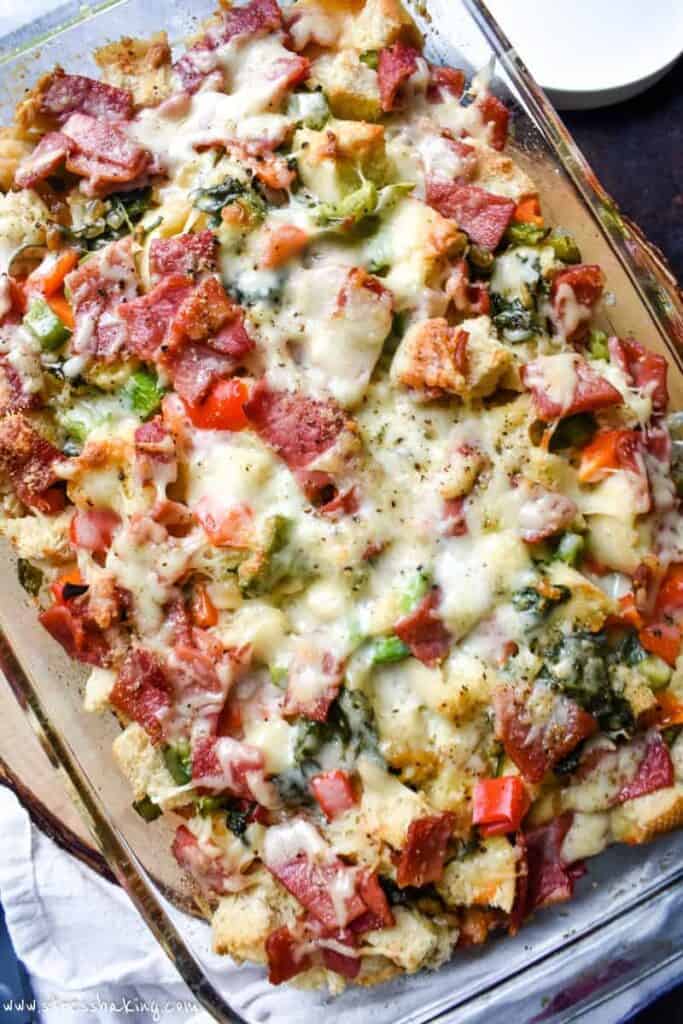 Overhead shot of colorful ham and cheese strata with peppers, spinach and cheese