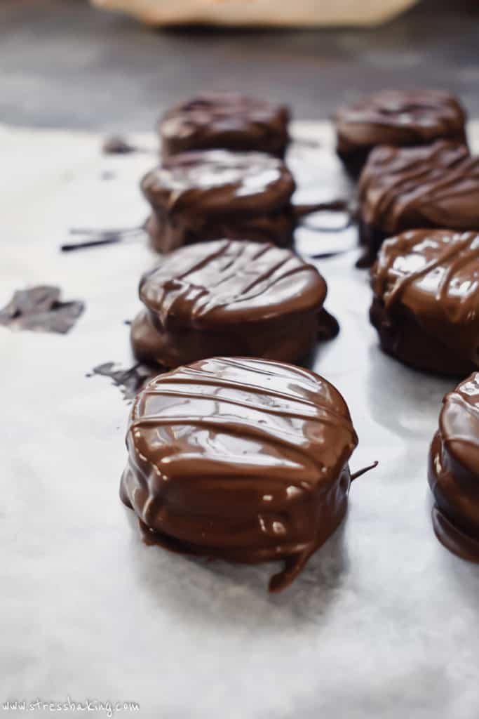 Chocolate covered crackers drying on wax paper
