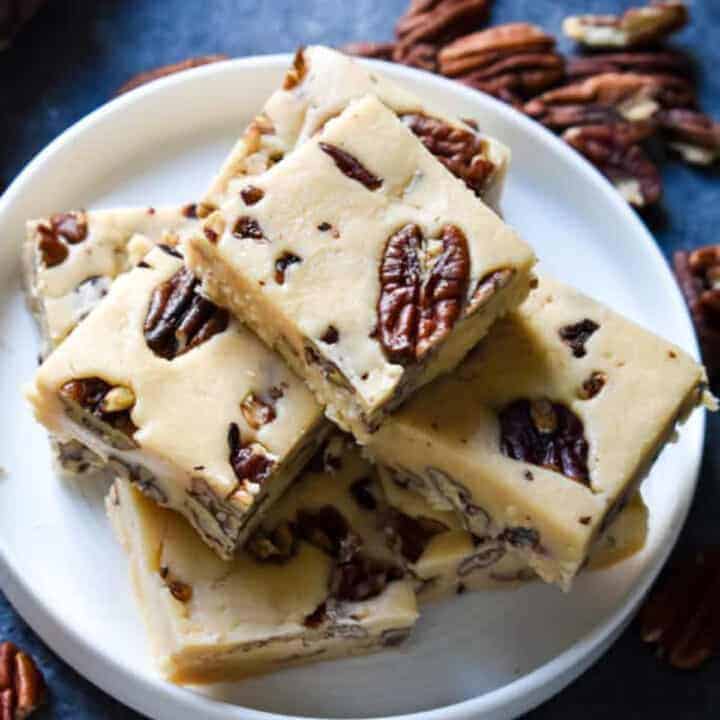 Overhead shot of butter pecan fudge stacked on a white plate