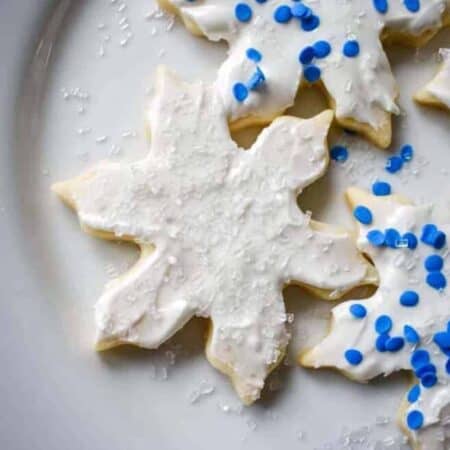 A plate of decorated snowflake sugar cookies