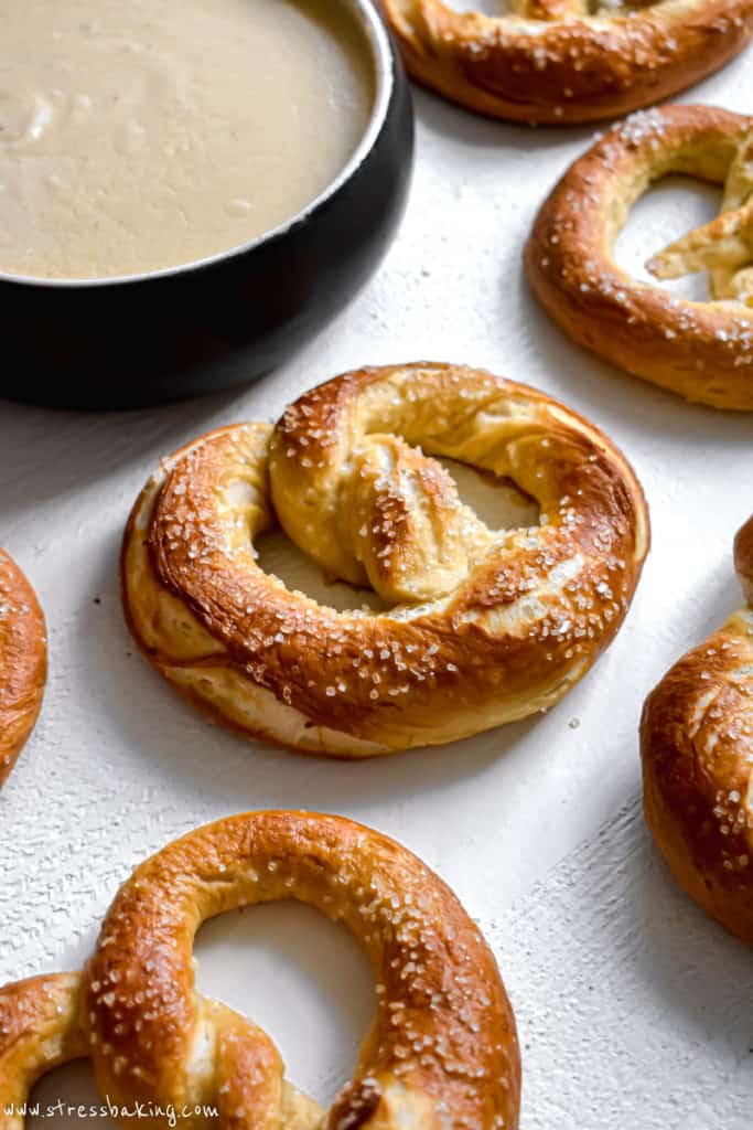 Close up of a golden brown soft pretzel on a white counter