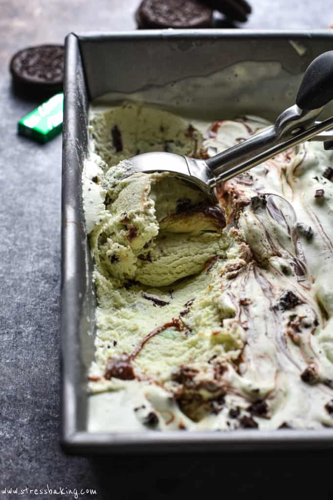 Mint chocolate chip ice cream being scooped out of a pan