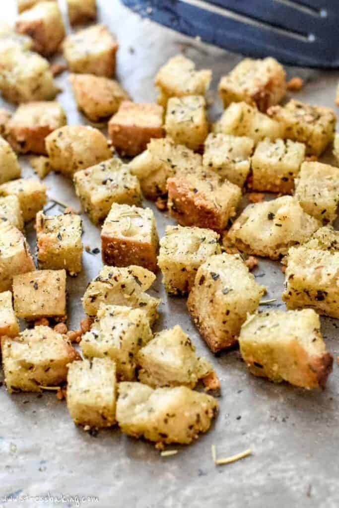 Freshly baked golden brown croutons on a baking sheet