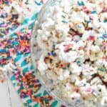 Overhead shot of colorful white chocolate popcorn covered in sprinkles