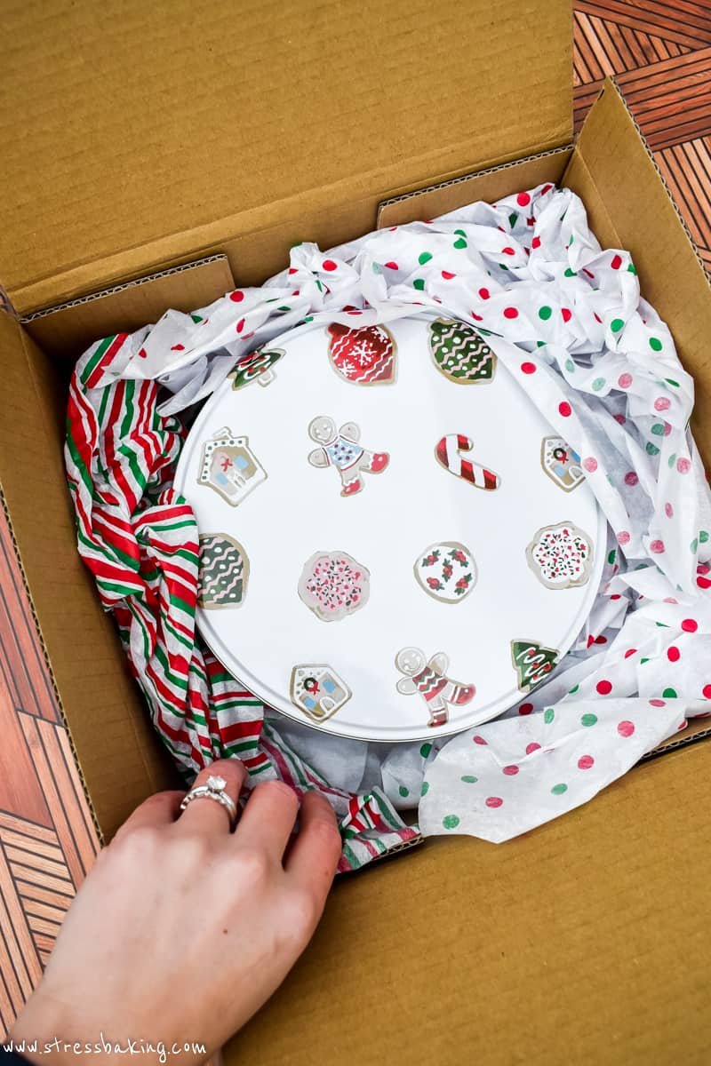 A holiday gift tin packed in a shipping box