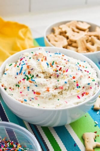 Dunkaroos Dip in a white bowl on a colorful placemat