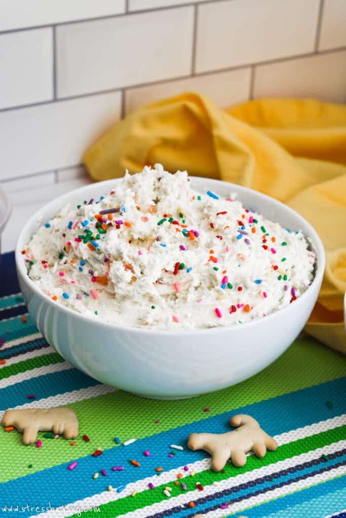 Dunkaroos Dip in a white bowl on a colorful placemat