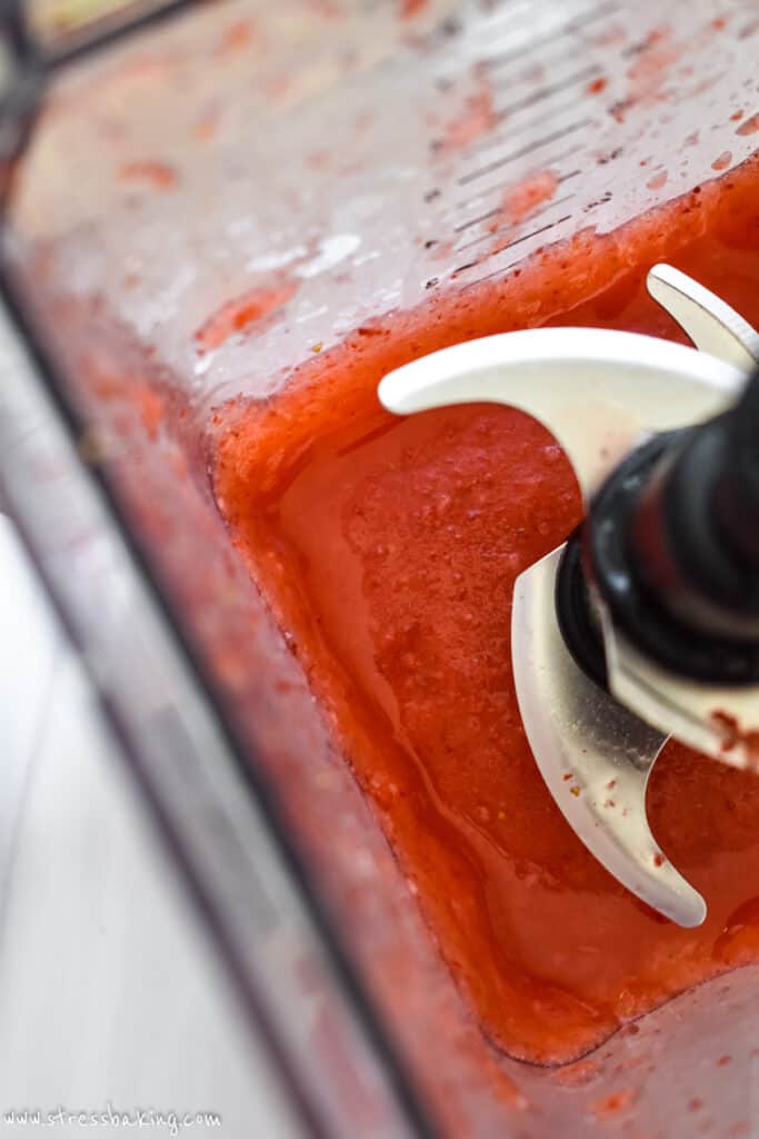 Frozen strawberry margarita in a blender