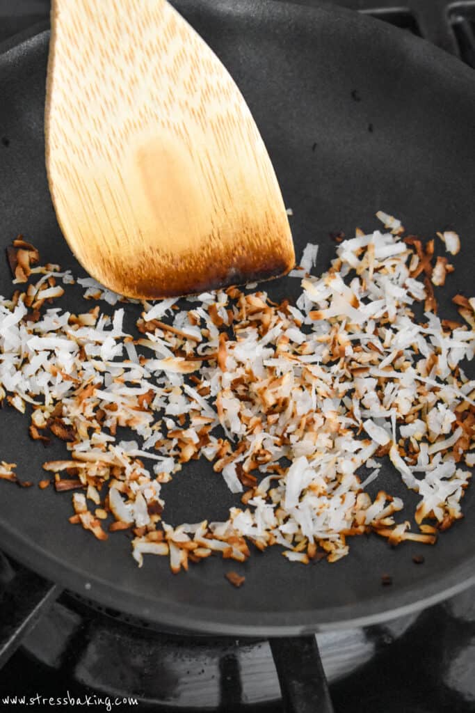 Shredded coconut being toasted in a saucepan