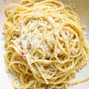 Freshly grated Parmesan on top of a bowl of spaghetti
