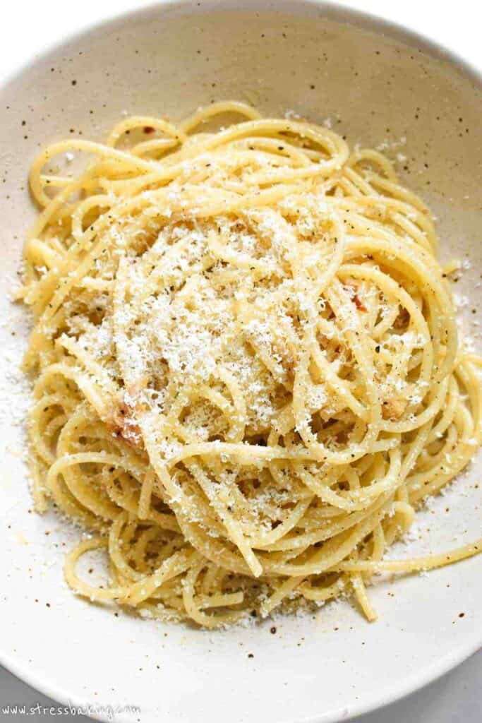 Freshly grated Parmesan on top of a bowl of spaghetti