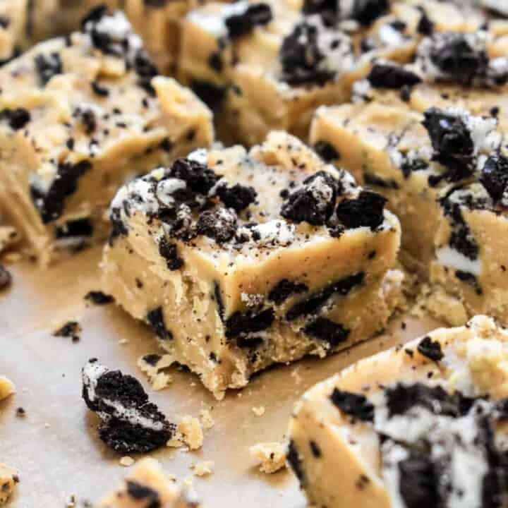 Close up of a piece of peanut butter fudge showing the chopped Oreos inside and on top